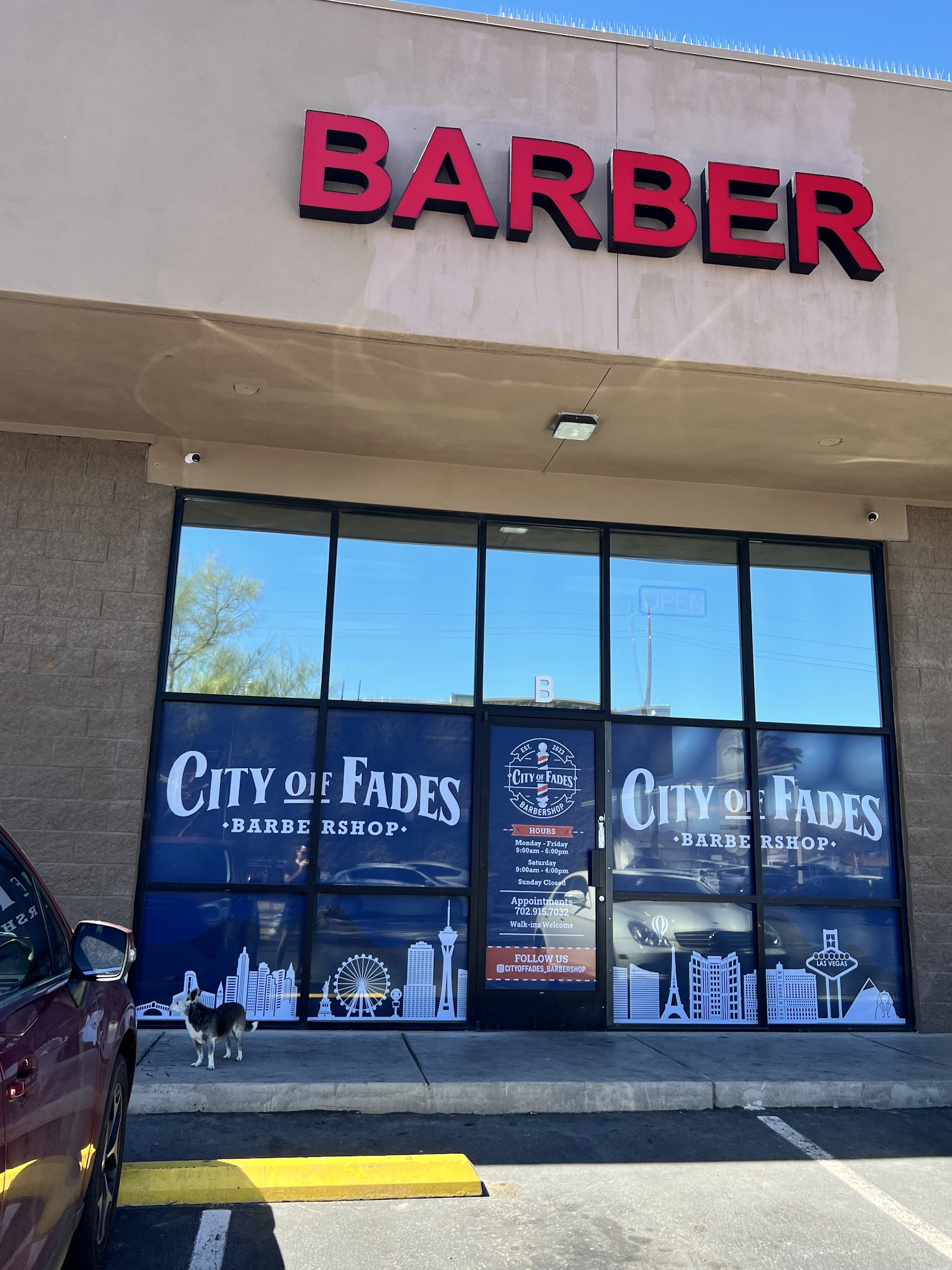 City of Fades Barbershop storefront with large red BARBER sign and window branding
